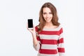 Smiling woman showing blank smartphone screen Royalty Free Stock Photo