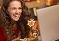 Smiling woman showing christmas cookies while having video chat Royalty Free Stock Photo