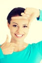 Smiling woman is showing frame by hands. Royalty Free Stock Photo