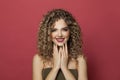 Smiling woman showing hands with green and black manicured nails on red background Royalty Free Stock Photo