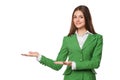 Smiling woman showing open hand palm with copy space for product or text. Business woman in green suit, isolated over white backgr