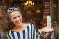 Smiling woman showing small Leaning Tower of Pisa souvenir Royalty Free Stock Photo