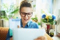 Smiling woman showing textbook in modern house in sunny day Royalty Free Stock Photo