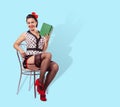 Smiling woman sitting on a chair with a book Royalty Free Stock Photo