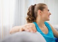 Smiling woman sitting on divan in living room Royalty Free Stock Photo