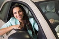 Smiling woman sitting at the wheel of her new car Royalty Free Stock Photo