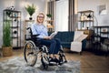 Smiling woman sitting in wheelchair with book in hands Royalty Free Stock Photo