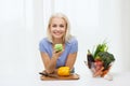 Smiling woman with smartphone cooking vegetables