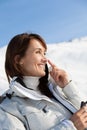 smiling Woman on the snow applying a protective cream