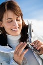 Smiling Woman on the snow applying a protective cream