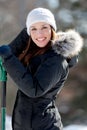 Smiling woman with snow shovel Royalty Free Stock Photo