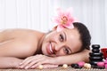 Smiling woman in spa salon, stone massage Royalty Free Stock Photo
