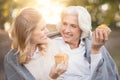 Smiling woman spending picnic with old mother outdoors Royalty Free Stock Photo