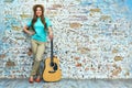 Smiling woman standing against grunge wall Royalty Free Stock Photo