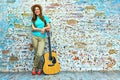 Smiling woman standing against grunge wall Royalty Free Stock Photo