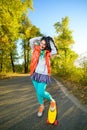 Smiling woman standing on color plastic penny