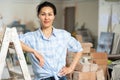 Smiling woman standing at indoor construction site