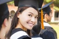 Smiling woman standing out from a graduation group