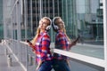 Smiling woman standing outside with phone and headphones Royalty Free Stock Photo