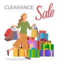 Smiling woman is standing with shopping bags. Big present boxes. Holliday sale and clearance concept