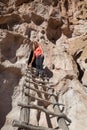 Woman Standing on a Wooden Ladder at Bandelier National Monument Royalty Free Stock Photo