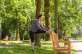 Smiling woman stretching in park on sunny day Royalty Free Stock Photo