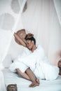 Smiling woman stretching sitting in blanket Royalty Free Stock Photo