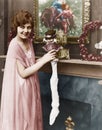 Smiling woman stuffing Christmas stocking