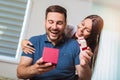 Woman surprises his boyfriend with present at home Royalty Free Stock Photo