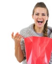 Smiling woman in sweater opening shopping bag Royalty Free Stock Photo