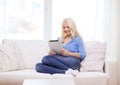 Smiling woman with tablet pc computer at home Royalty Free Stock Photo