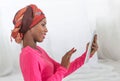 Smiling woman with tablet wearing a headscarf