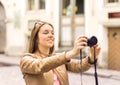 Smiling woman taking photos with digital camera. Royalty Free Stock Photo