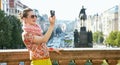 Smiling woman taking photos with digital camera in Prague Royalty Free Stock Photo