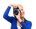 Smiling woman taking picture with digital camera Royalty Free Stock Photo