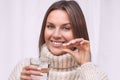 Smiling woman taking a pill with cod liver oil omega-3. Vitamin D, D3, fish oil Royalty Free Stock Photo