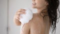 Smiling woman taking shower enjoying soft foam of aromatic gel Royalty Free Stock Photo