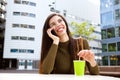 Smiling woman talking with cellphone at cafe Royalty Free Stock Photo