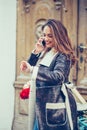 Smiling woman talking on the mobile phone and checking the time on the watch Royalty Free Stock Photo