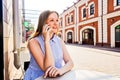 Smiling woman talking on mobile phone outdoors. Royalty Free Stock Photo