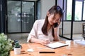 Woman talking on mobile phone and using digital tablet. Royalty Free Stock Photo