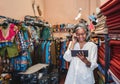 Smiling woman talking on a phone in her fabric store Royalty Free Stock Photo