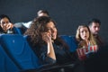 smiling woman talking on smartphone while watching movie Royalty Free Stock Photo