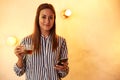 Smiling woman with tea and cellphone Royalty Free Stock Photo