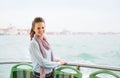 Smiling woman tourist standing on a boat in Venice Royalty Free Stock Photo