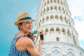 Smiling woman tourist taking photo of Leaning Tower of Pisa Royalty Free Stock Photo