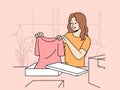Smiling woman unpack orders at home shopping online