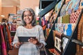 Smiling woman using a digital tablet in her textiles shop Royalty Free Stock Photo