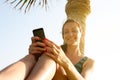 Smiling woman using mobile phone outdoor. Royalty Free Stock Photo
