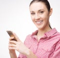 Smiling woman using a mobile phone Royalty Free Stock Photo